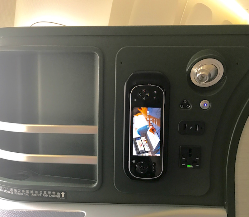 In-Flight Entertainment Remote, Power Source, And Seat Storage 